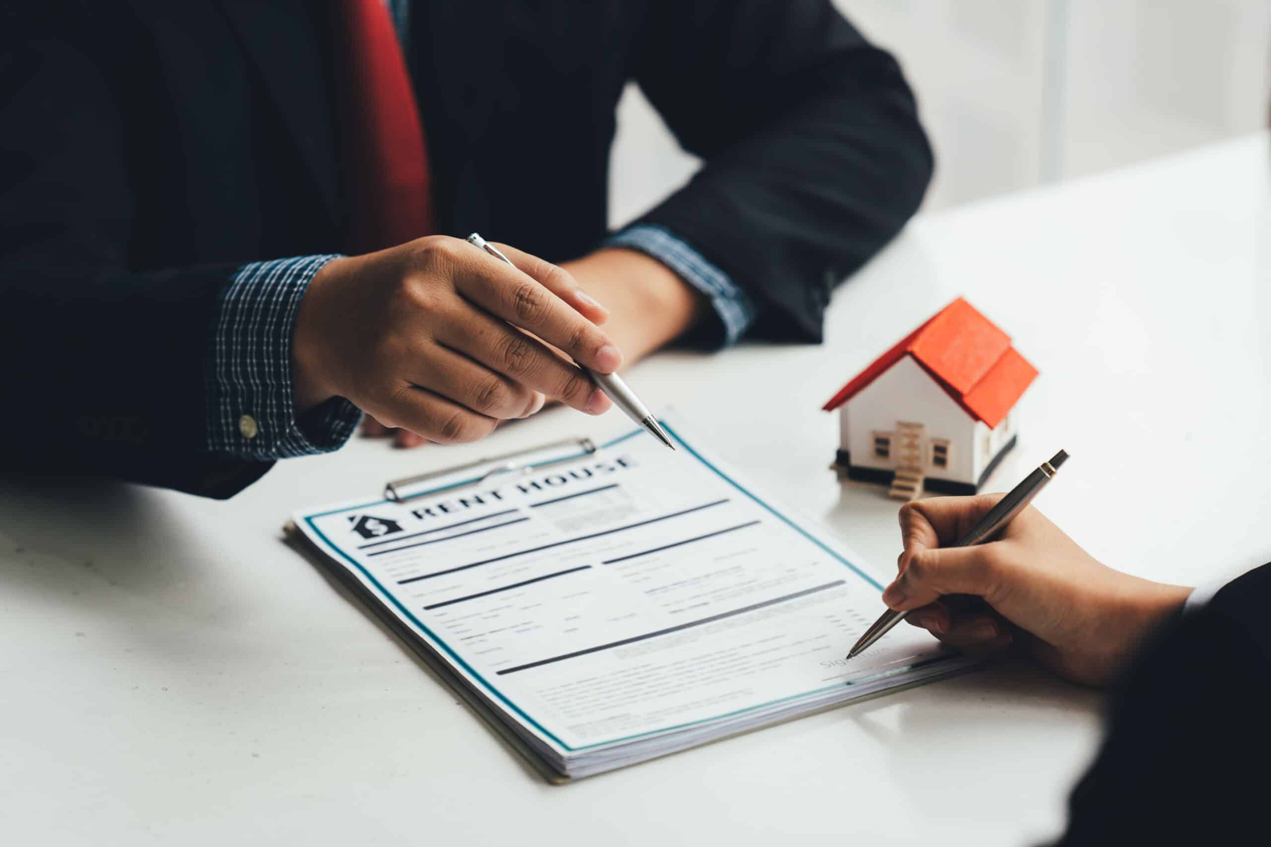 Property owner and property manager reviewing a rental agreement